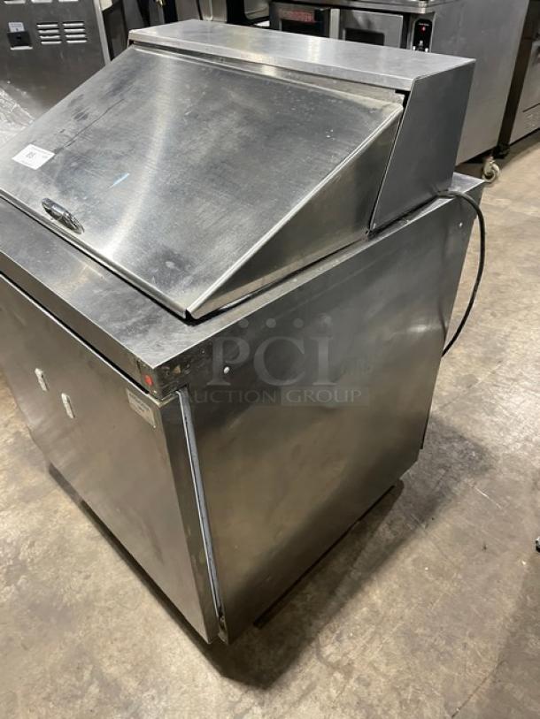 Delfield stainless steel Bain Marie prep table model 4432N-12M, one-door refrigerated base, on casters, visible wear.