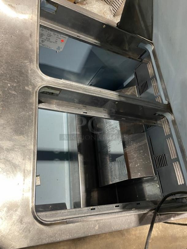 Delfield 4432N-12M stainless steel prep table with 1-door refrigerated base on casters, good condition.