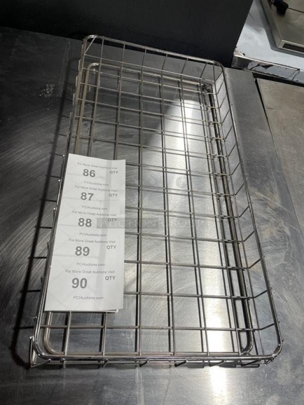 Commercial chrome-plated full-size bagel/pastry wired rack in excellent condition, with visible auction tags for item tracking.