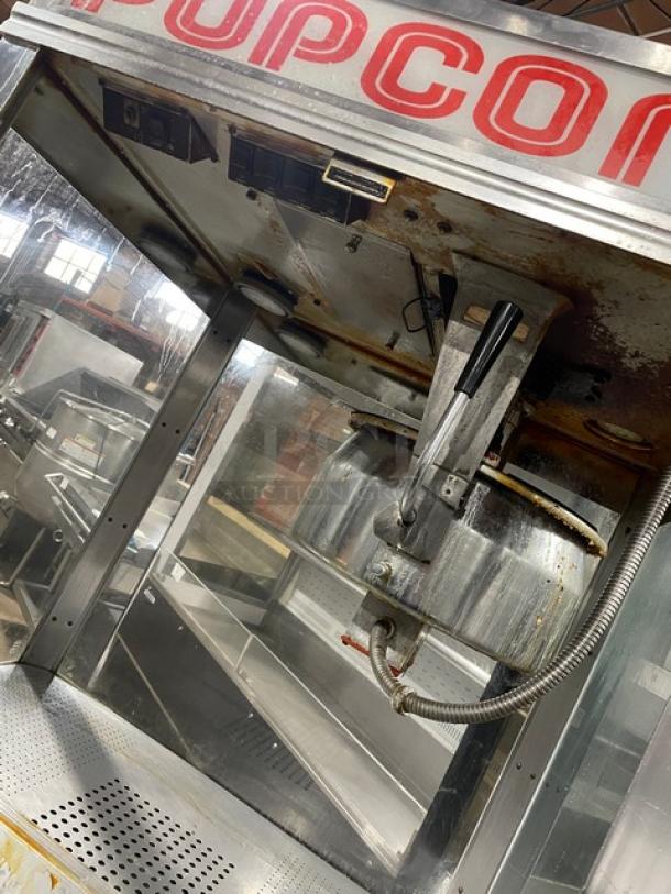 Gold Medal 2010TM popcorn popper machine, commercial stainless steel, electric-powered, heated corn deck, cabinet style, used.