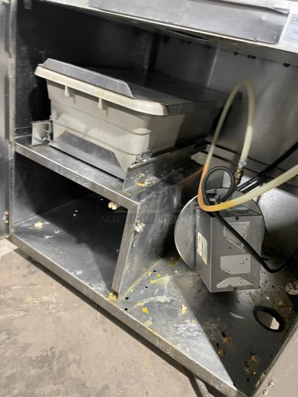 Gold Medal 2010TM stainless steel popcorn popper machine, features heated corn deck; visible wear but structurally intact.