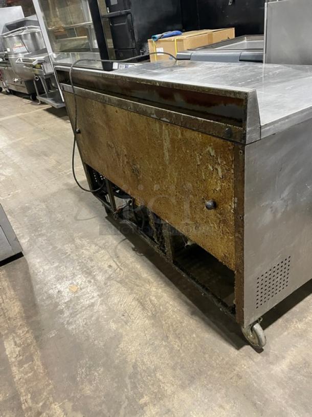 True Commercial Stainless Steel 2-Door Worktop Table/Undercounter Refrigerator, Model TWT-60, on casters, with backsplash.