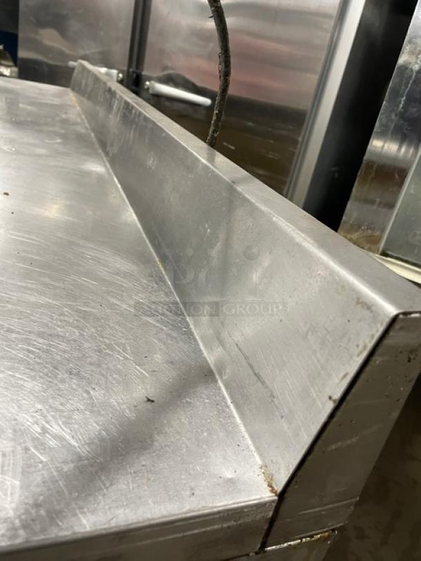 True Commercial Stainless Steel 2-Door Worktop Refrigerator, Model TWT-60, with backsplash, poly-coated rack, on casters.