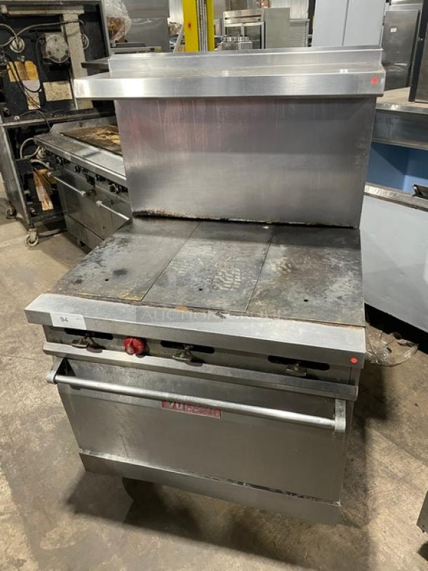 Vulcan 36L stainless steel French top range/oven, natural gas, on casters. Visible wear, model 36L, SN: A8112971OUT.