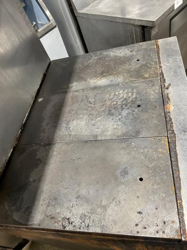 Vulcan 36L commercial stainless steel natural gas French top range/oven in used condition, with visible wear, on casters.