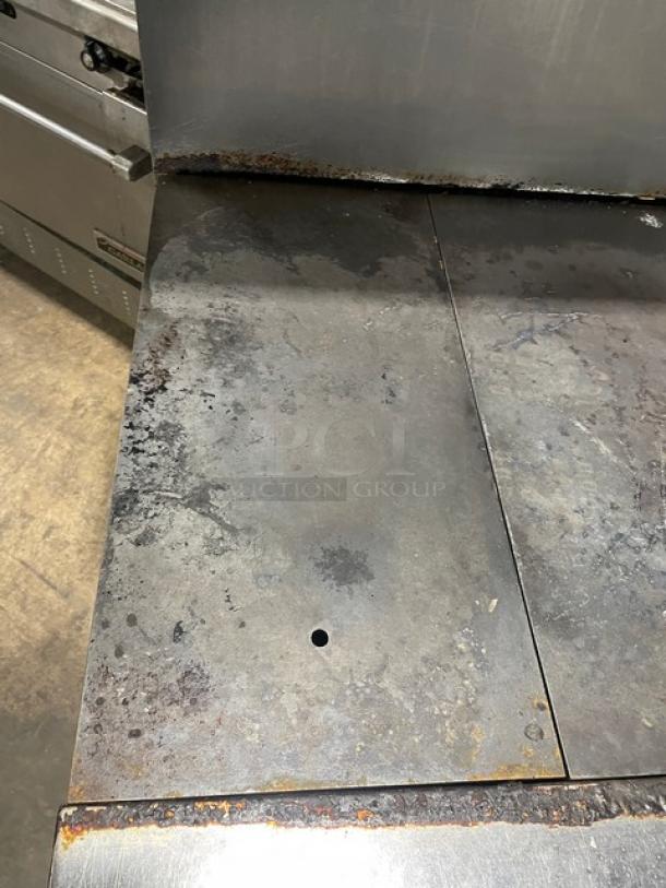 Vulcan 36L stainless steel French top range/oven, natural gas, on casters, visible wear and rust on surface.