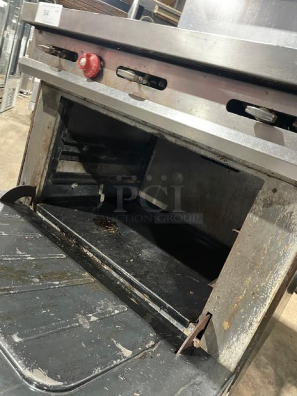 Vulcan 36L commercial stainless steel natural gas French top range/oven combo, visible wear, on casters, SN: A8112971OUT.