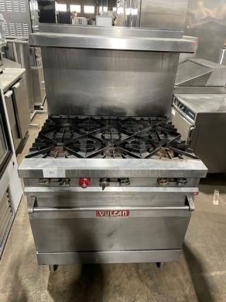 Vulcan 36L commercial stainless steel 6-burner range/oven on casters, with backsplash and overhead salamander shelf.