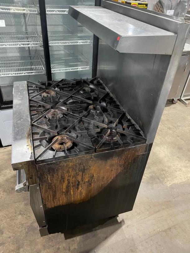 Vulcan 36L commercial stainless steel 6-burner gas range/oven combo on casters, with backsplash and overhead salamander shelf.