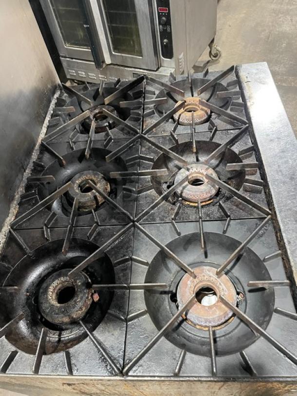 Vulcan 36L stainless steel 6-burner range/oven combo with backsplash, overhead salamander shelf, on casters, natural gas powered.