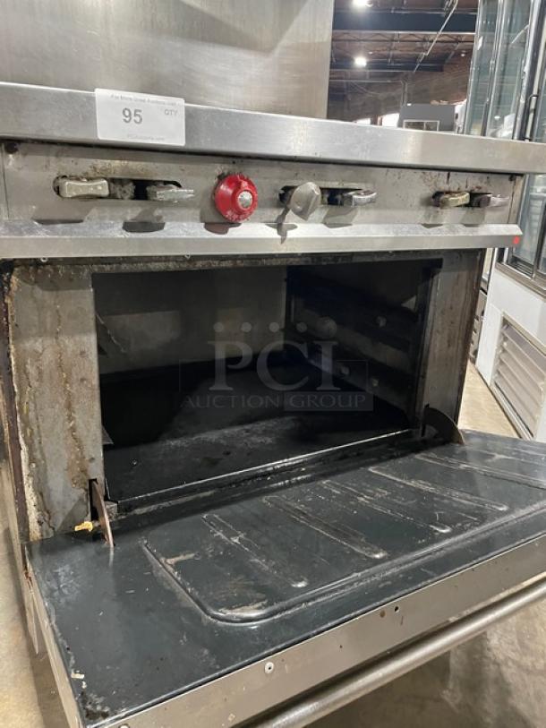 Vulcan 36L commercial 6-burner range/oven, stainless steel, natural gas, with back splash, salamander shelf, on casters.