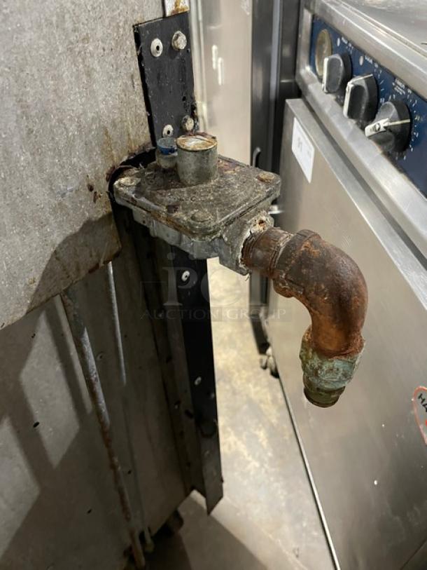 Vulcan 36L commercial gas range/oven, 6 burners, stainless steel, with back splash and overhead salamander shelf, on casters.