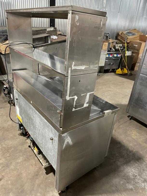 Asber stainless steel 2-door refrigerated prep table with overhead dual storage shelf, model APTS4812, on casters.