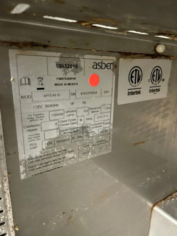 Asber APTS4812 2-Door Refrigerated Prep Table, stainless steel, SN: 8102279534, ETL certified, on casters, overhead storage.