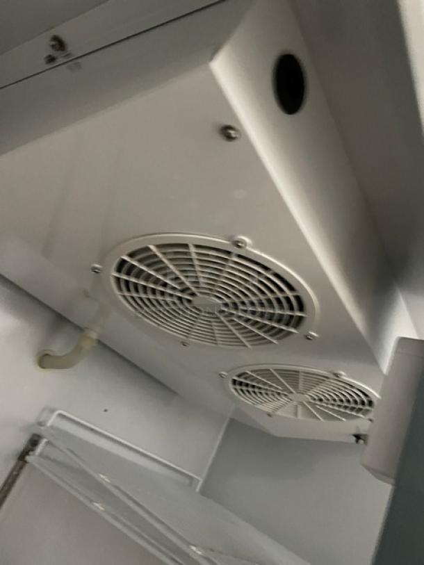 Maxx Cold MXCF49FD stainless steel freezer interior, showing fans and a poly-coated wire rack, in clean condition.