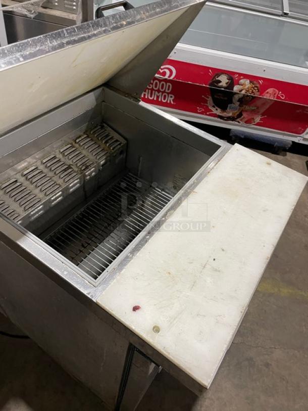 Continental stainless steel prep table, model DW27-12M. Bain Marie style with refrigerated base, cutting board, shelves.