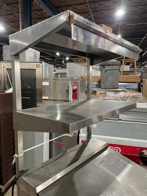 Continental stainless steel prep table, Model DW27-12M, with refrigerated base, cutting board, dual shelves, and poly-coated rack.
