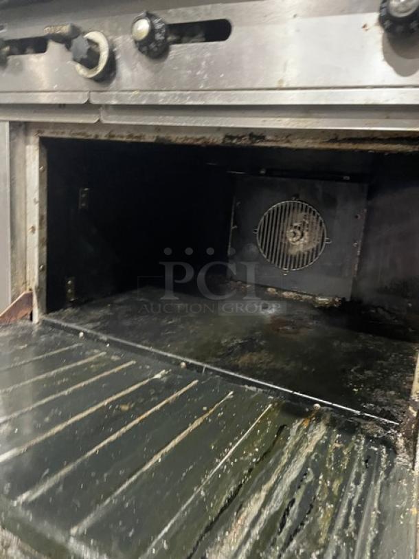 Garland H280 Series commercial stainless steel griddle range with double oven, overhead salamander shelf, and casters. Model H289RC72GTH.