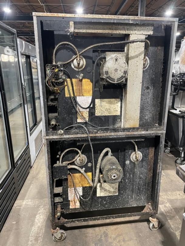 Blodgett commercial stainless steel double-stacked convection oven, gas-powered, solid-state control, on casters, with wired rack.