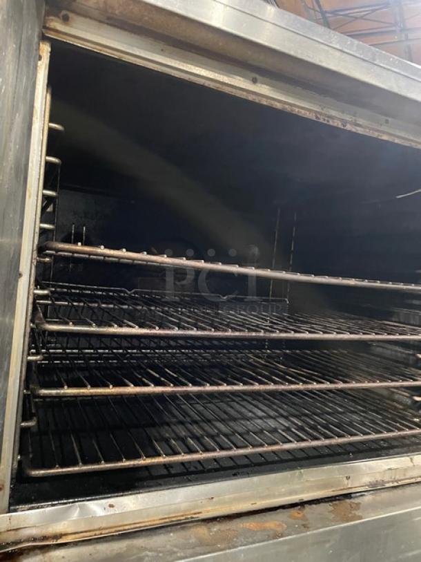 Blodgett stainless steel commercial double-stacked convection oven with solid-state controls and wired oven racks, on casters.