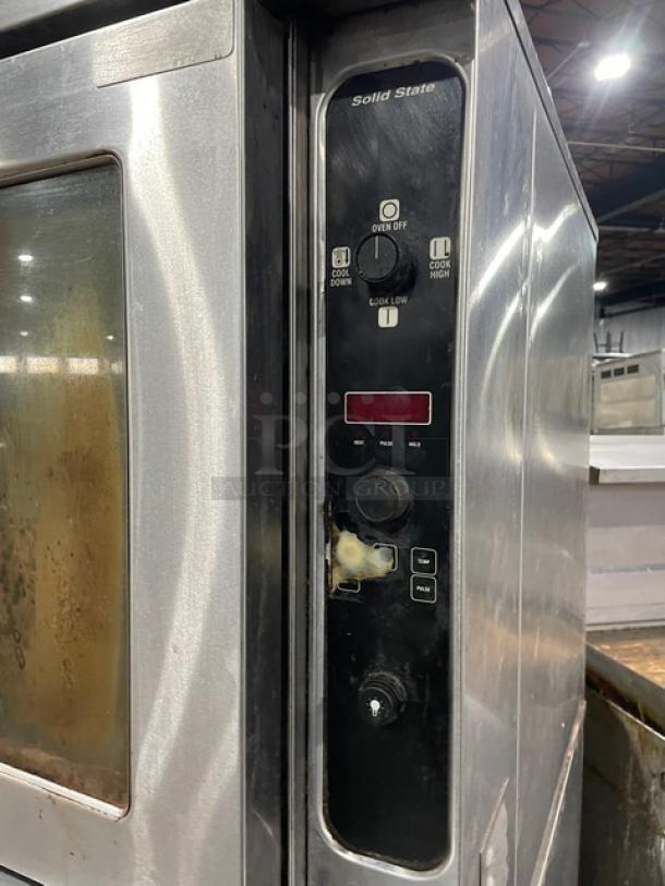 Blodgett stainless steel double stacked convection oven with solid state control panel, gas-powered, on casters, with wired rack.