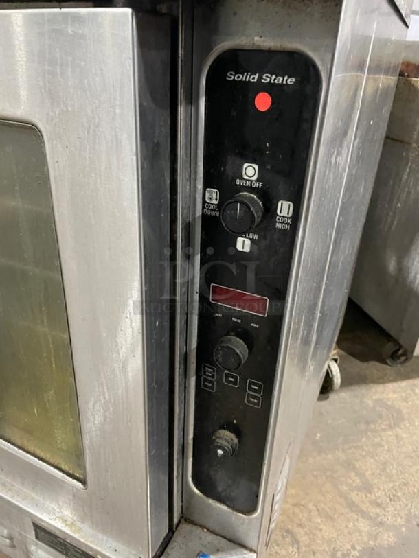 Blodgett commercial stainless steel gas-powered double-stacked convection oven with solid-state control, wired rack, on casters.