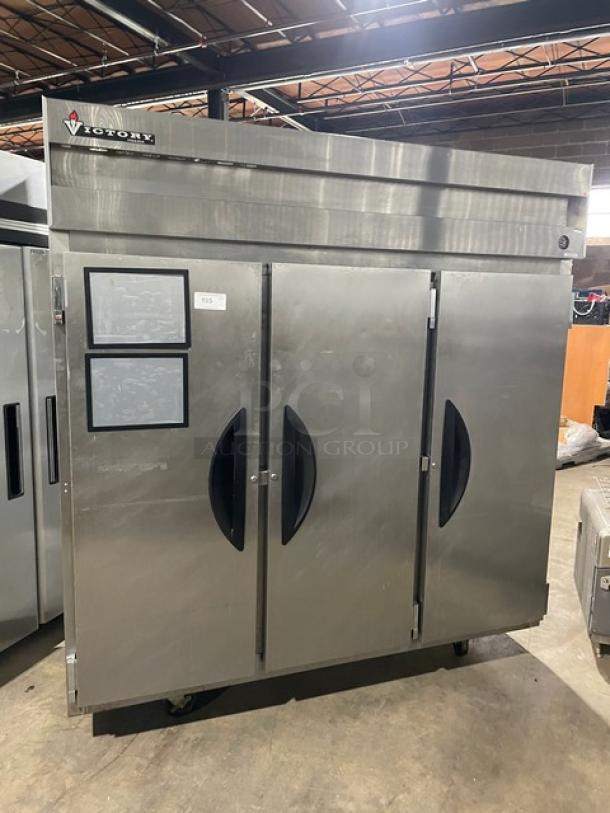 Victory Commercial Stainless Steel 3-Door Reach-In Freezer with poly-coated wire rack and casters, in good condition.