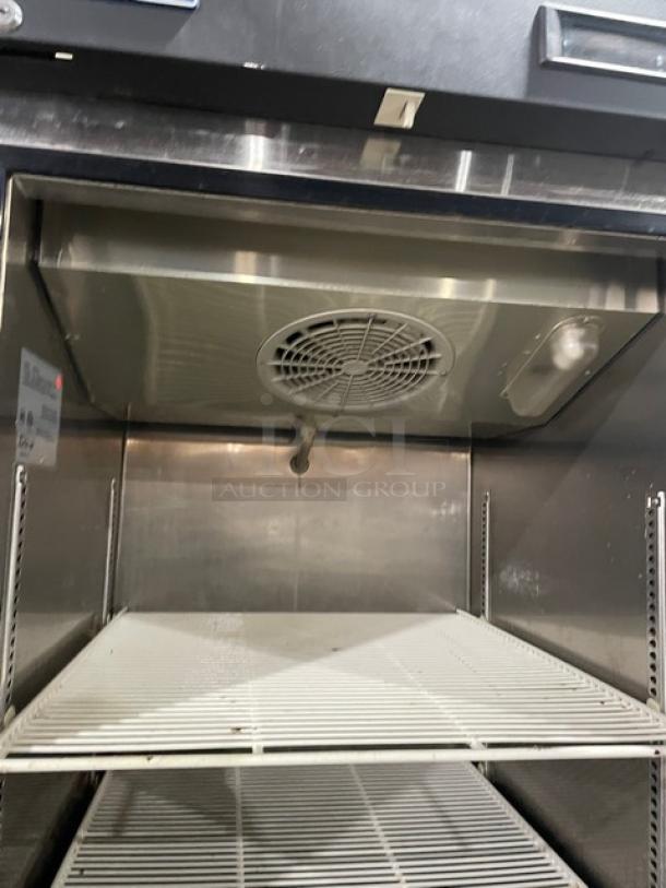 Turbo Air M3 Series stainless steel half-door refrigerator, model M3R24-2, with poly-coated wire racks and visible interior fan.