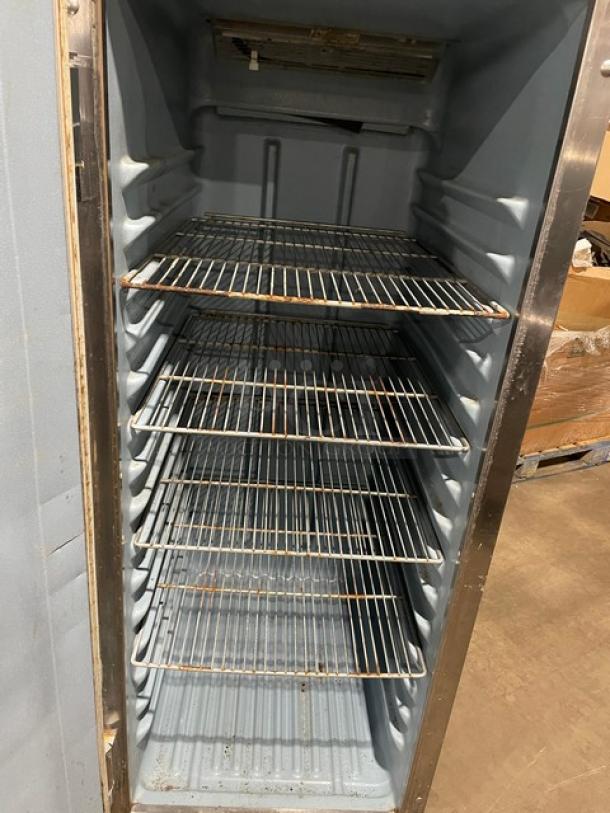 Delfield 6000-XL Stainless Steel Reach-In Freezer, single door, poly-coated racks, on casters, interior view.
