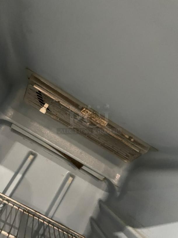 Delfield 6000-XL Series reach-in freezer interior, stainless steel, poly coated wire rack, on casters.