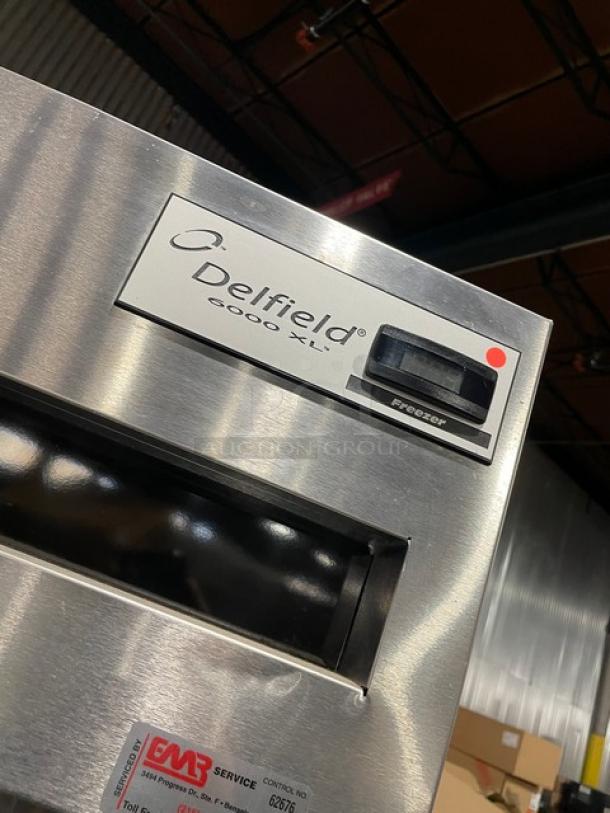 Delfield 6000-XL commercial stainless steel single door reach-in freezer with poly-coated wire rack, on casters.