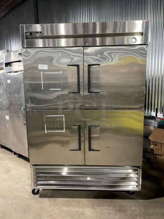 True T-49F-4 commercial stainless steel half-door reach-in freezer on casters, with poly-coated wire rack, model tagged.