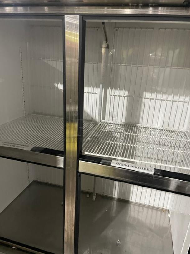 True T-49F-4 commercial stainless steel freezer, half-door, dual section, poly-coated rack, 115V, on casters, SN: 5197569.
