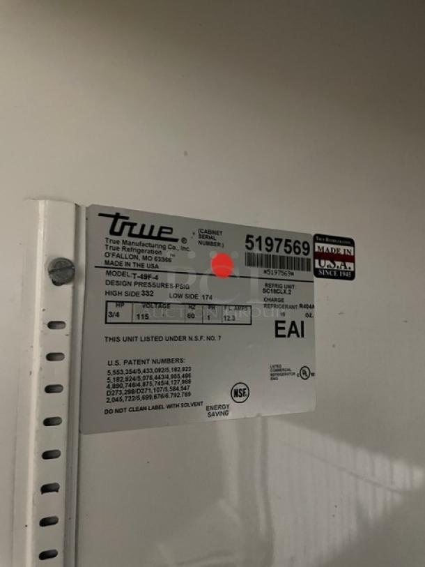 True T49F4 commercial stainless steel half-door freezer, SN 5197569, 115V, 1 phase, with poly-coated wired rack, on casters.