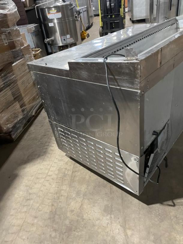 Continental stainless steel refrigerated prep table with single door, 3 drawers, and poly coated rack on casters.