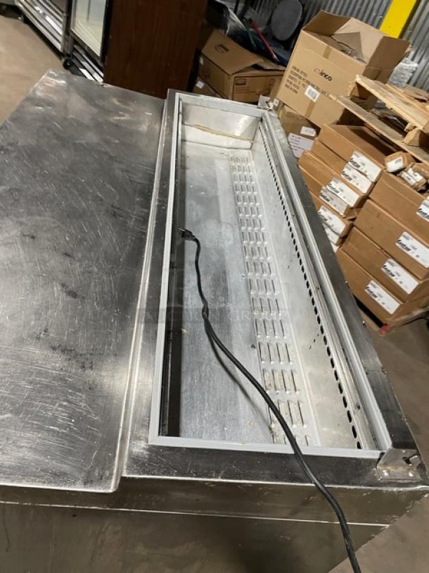 Continental stainless steel refrigerated prep table with single door, three drawers, poly-coated rack, on casters, used condition.