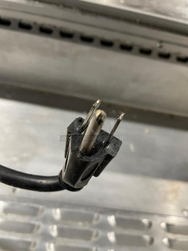 Continental stainless steel single door/3 drawer refrigerated prep table, poly coated rack, on casters, power plug shown.