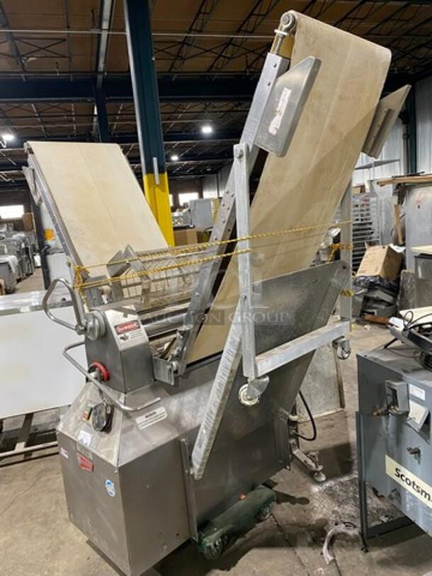 Moline commercial electric reversible dough sheeter/molder, free-standing, metal finish, working condition, industrial setting.