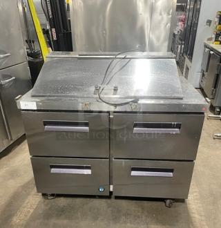 Hoshizaki stainless steel 4-drawer refrigerated prep table, Bain Marie style, on casters, with visible top openings for storage.