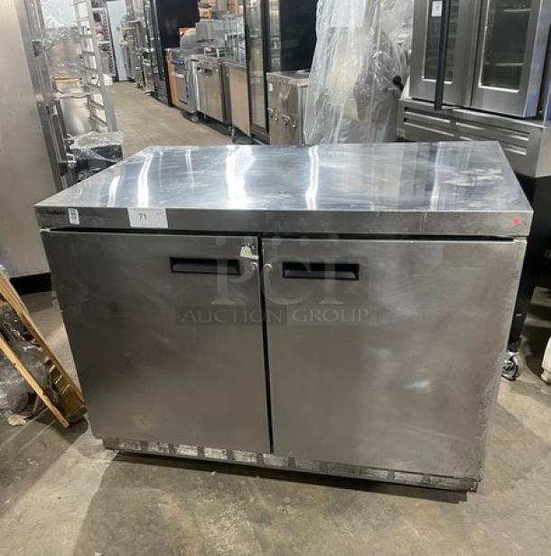 Delfield UC4448N-A8 stainless steel 2-door undercounter refrigerator, poly-coated wired rack, on casters, pre-owned.