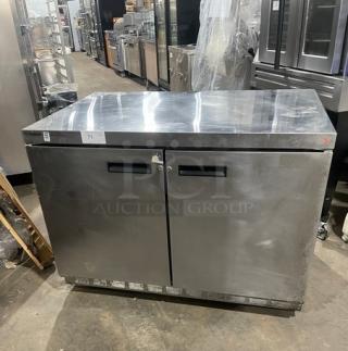 Delfield UC4448N-A8 stainless steel 2-door undercounter refrigerator, poly-coated wired rack, on casters, pre-owned.