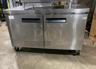 Commercial stainless steel 2-door refrigerated lowboy worktop cooler with poly-coated wired rack, on casters.