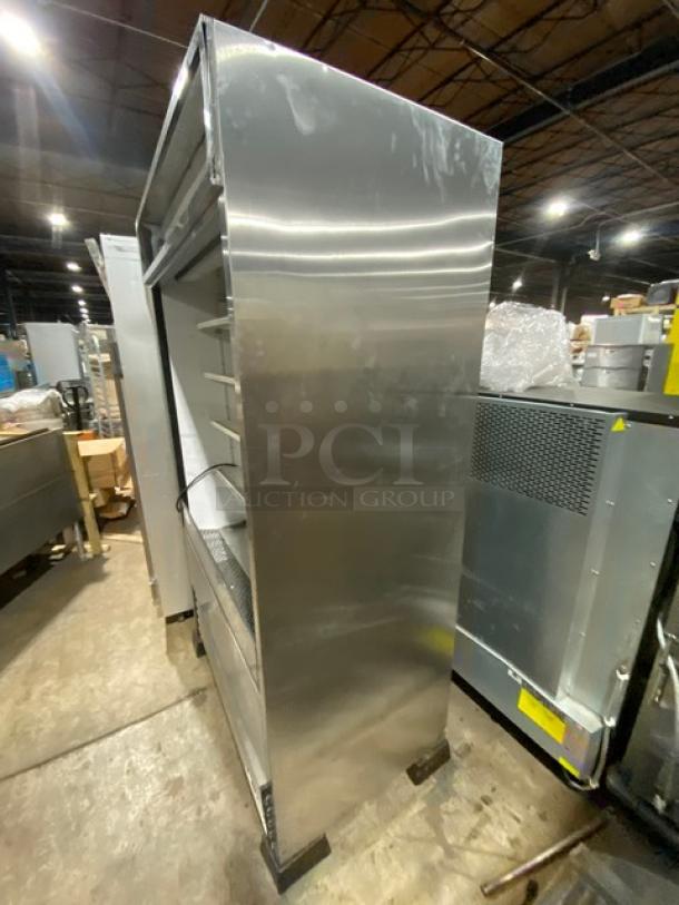 True commercial stainless steel refrigerated grab-n-go display case, model TAC48LD, with adjustable wired racks.