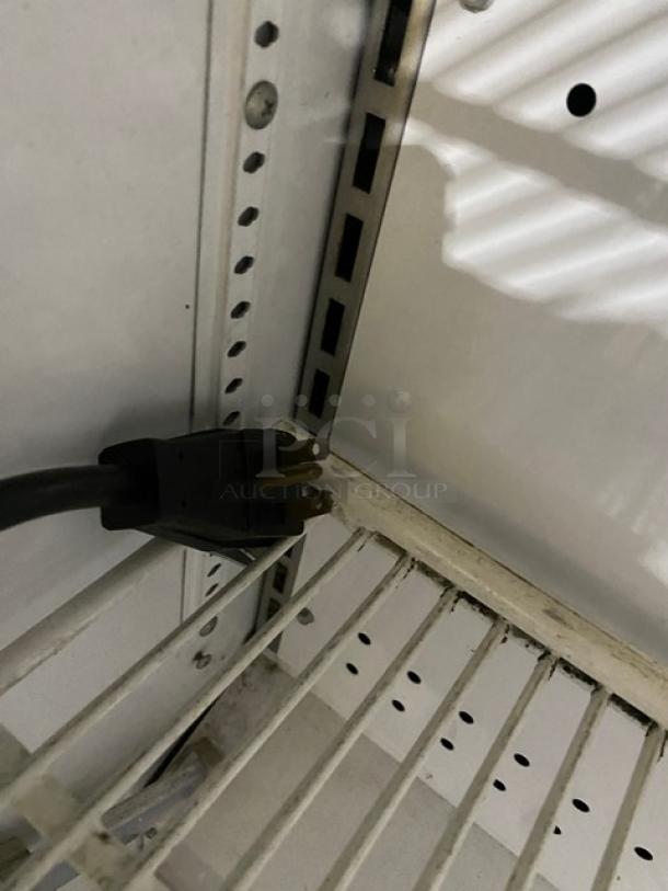 True TAC48LD commercial refrigerated display case, stainless steel, adjustable poly coated rack, Model SN: 9289142, 208-230V, on legs.