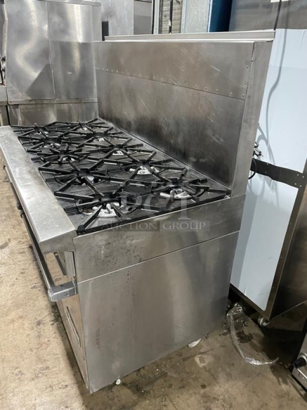 Garland H284 10-burner range/double oven, stainless steel, natural gas, with backsplash and wired oven rack, on casters.