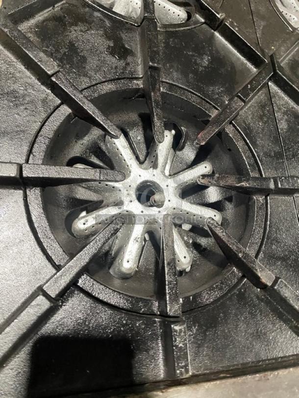 Garland H284 commercial stainless steel 10-burner range, natural gas, double oven. Features splashback, wired rack, on casters.