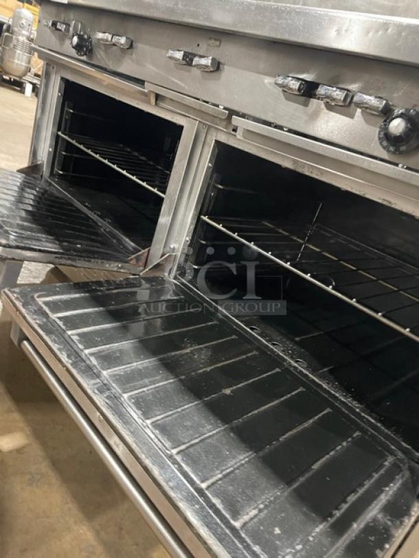 Garland H284 stainless steel 10-burner range with double ovens, backsplash, wired oven rack, on casters. Natural gas powered.