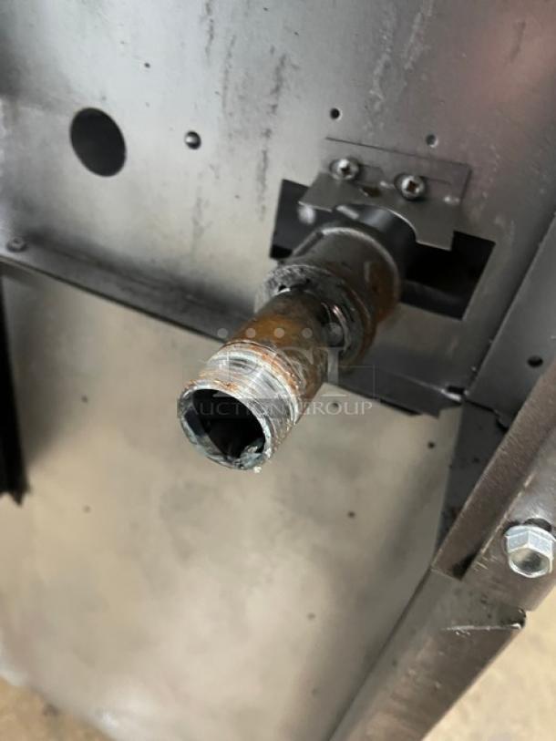 Close-up of Garland Model H284 gas connector on a commercial stainless steel range/oven combo.