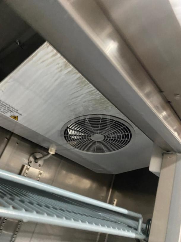 Sir Lawrence SLFRZ2D stainless steel reach-in freezer, poly-coated racks, on casters, 115V 1 Phase, excellent condition.