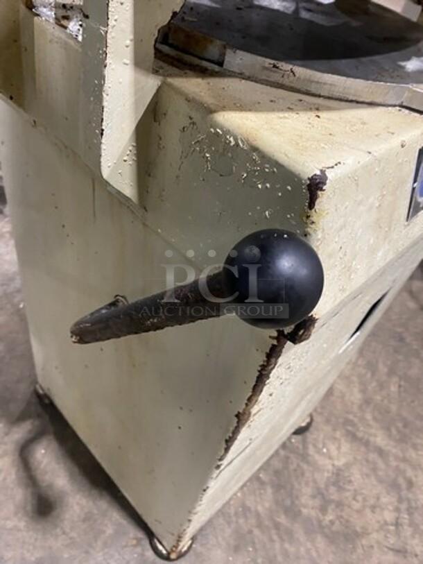 Benier commercial dough divider/rounder in used condition, featuring a crank handle. Model requires 220V. Rust visible on edges.